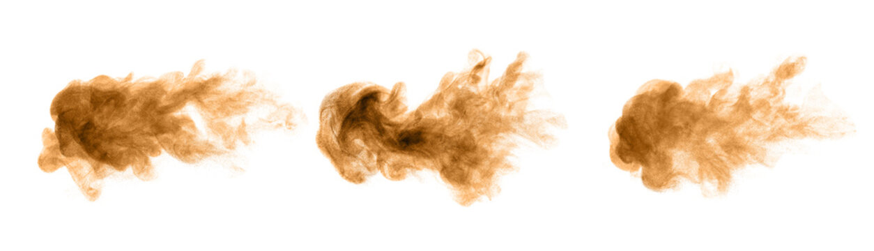 Golden and brown sand dust like smoke swirling in a bomb storm, spraying in the air as colorful lumps on a black and white background.
