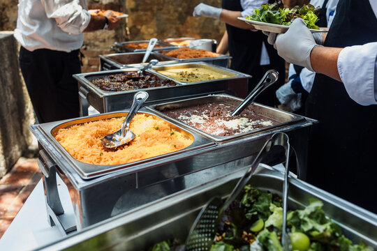Catering staff serving Mexican food at an event buffet in Mexico Latin America, plate of mexican rice and sauces 