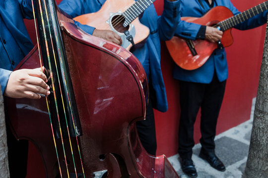 Group of mexican musicians called Trio playing guitar in the street in Mexico Latin America