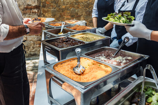 Catering staff serving Mexican food at an event buffet in Mexico Latin America, plate of mexican rice and sauces 