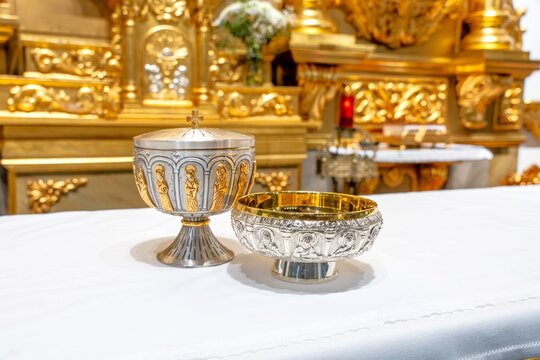 Eucharist vessels on altar with golden reredos