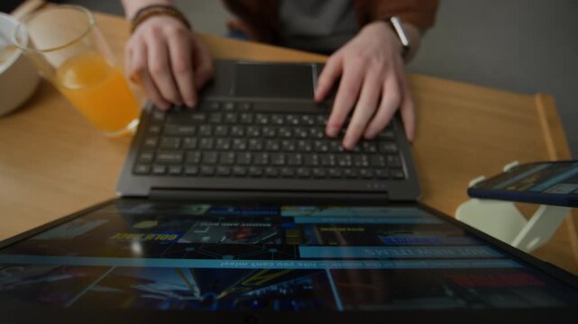 Hands of unrecognizable person browsing online game store on laptop indoors. Footage is perfect for digital entertainment promos and app store marketing campaigns