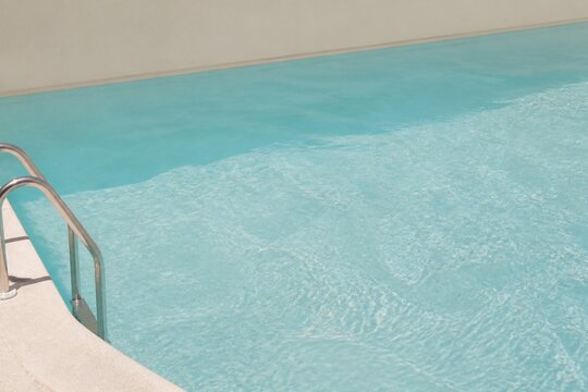 Pale Aqua Swimming Pool with Chrome Ladder