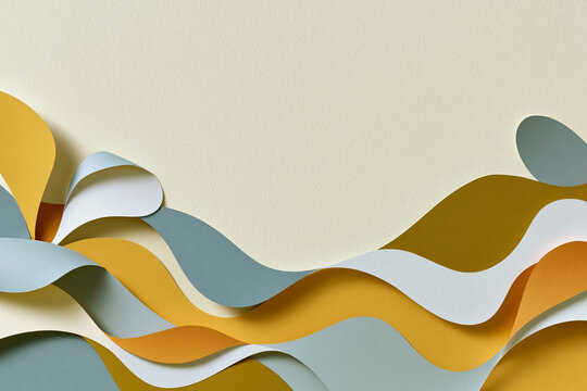 Abstract layered paper waves in mustard yellow, blue and white colors on textured cream background with flowing curves and copy space
