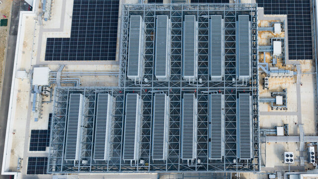 Aerial view of advanced cooling infrastructure and solar panels on the roof of a hyperscale data center in Milan, Lombardy, Italy.