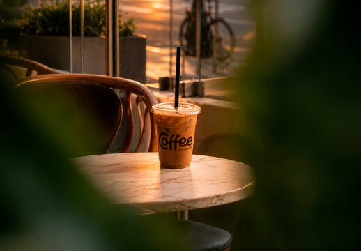 Coffee Cup on Cafe Table Mockup