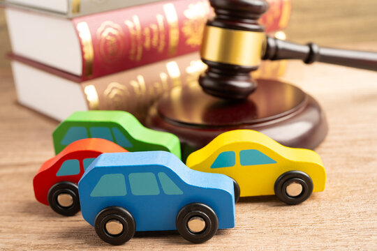 Hammer gavel judge with car vehicle accident, insurance coverage claim lawsuit court case.