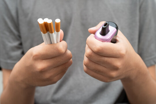 Man holding electronic cigarettes, no smoking.