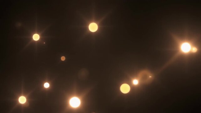 Bright glowing orbs of light shine against a dark background in this abstract night scene.