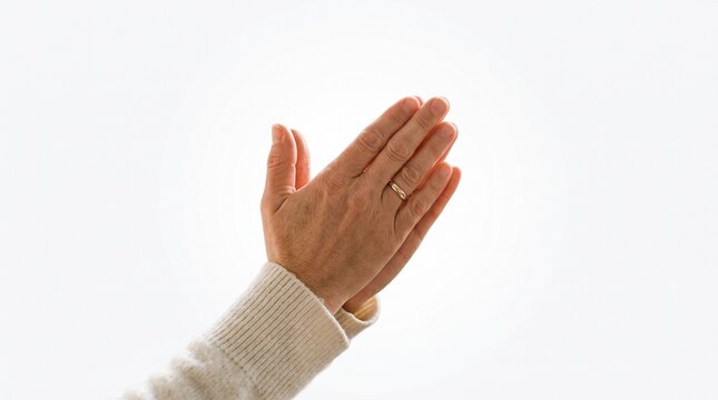 Hands gently folded in prayer against a light background