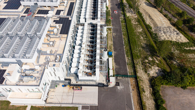 Aerial view of a modern hyperscale data center facility with cooling units and rooftop infrastructure in Settala, Lombardy, Italy.