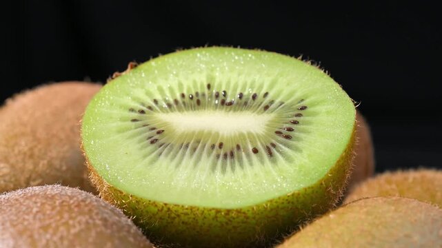 Fresh Kiwi Slices on Plate with Black Background