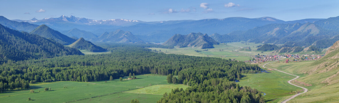 Rural landscape in the Altai Mountains, a spacious valley, summer greenery, panoramic view