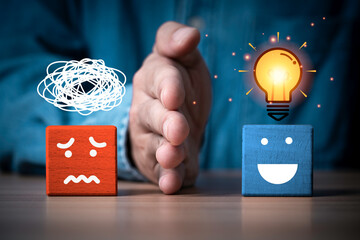 Mental health resilience and positive mindset concept showing a hand separating stress from solution, with worried and happy faces for problem solving, clarity, emotional balance and personal growth. © Dilok