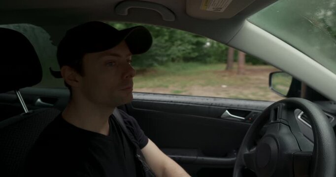Man stopping the car at the end of forest road trip with audio included