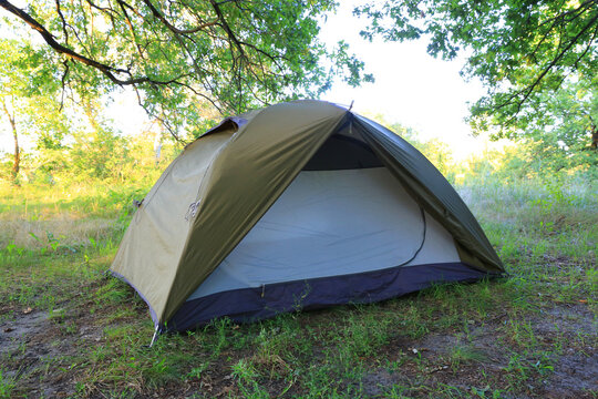 Camping tent set up in a serene natural environment