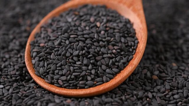 Black Sesame Seeds in Wooden Spoon