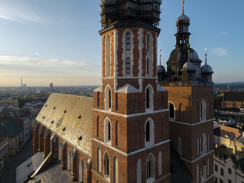 Aerial view of St. Mary's Basilica with its distinctive brick towers and gothic architecture, overlooking the historic city center of Krakow, Malopolskie Voivodeship, Poland.