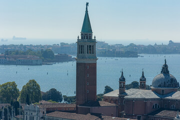 Aerial view of San Giorgio Maggiore bell tower and basilica over the Venetian lagoon. A classic Italian panorama ideal for European travel, historical architecture, tourism, and vacation themes © fabrizio maffei