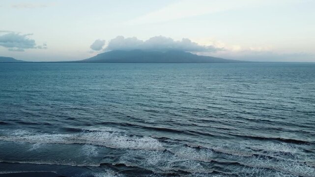View of Bali Island across the Bali Strait from the coast of East Java, Indonesia.