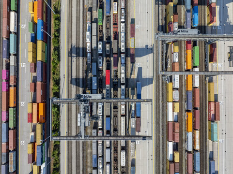 Munich, Germany - 20 July 2026: Aerial view of Container Depot Munchen with rows of colorful shipping containers, railway tracks, and gantry cranes.