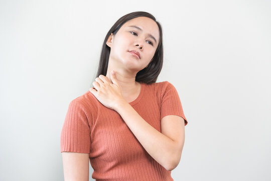 Pain body muscles stiff problem, asian young woman, girl painful with neck pain body ache from work, holding massaging rubbing shoulder hurt, sore on white background. Health care and medicine concept