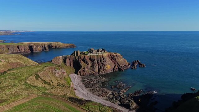 Beautiful cinematic Aerial footage of Dunnottar Castle and Dramatic Cliffs, Stonehaven Scotland &ndash; Historic Medieval Fortress on the North Sea	