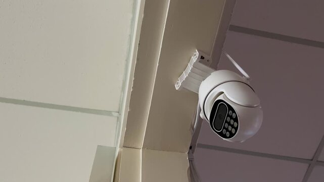 Modern cctv security camera with ptz functions and led illumination hanging from the ceiling, actively monitoring and recording for safety, surveillance, and property protection.