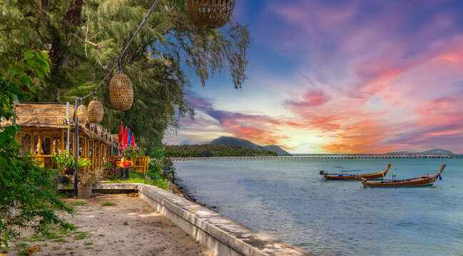 Colourful Skies Sunset over Rawai Beach in Phuket island Thailand. Lovely turquoise blue waters, lush green mountains colourful skies and beautiful views of Pa Tong Patong