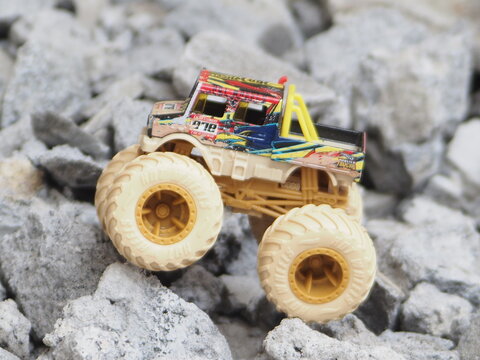 Indonesia - May 8, 2025 : Mini toy of monster truck at outdoor with blurred background. Automotive photography concept design. Monster Jam car.