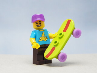 Fototapeta premium Indonesia - April 28, 2025 : Mini toy of action figure at table with blurred background. Toy photography concept design. Minifigure of skate board athlete character at skate park.