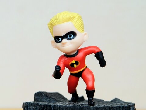 Indonesia - February 22, 2026 : Mini toy of action figure at table with blur background. Miniature photography concept design. Minifigure of Dashiell Parr character from Incredible cartoon movie.