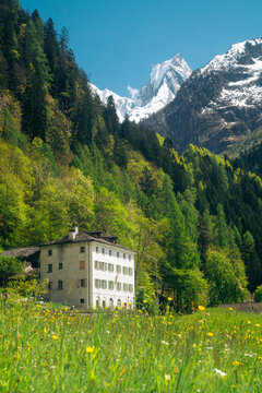 Historic alpine house in Promontogno with Piz Badile peak, Bregaglia valley, Switzerland