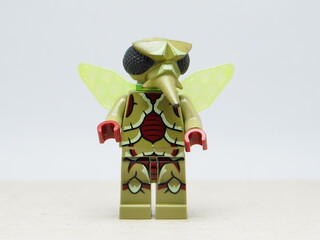 Obraz premium Indonesia - December 10, 2025 : Mini toy of action figure at outdoor with blurred background. Miniature photography concept design. Minifigure of Green insect Mosquito character.