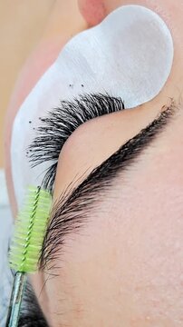 Close up of female eye with eyelash extensions ,eyelash extension procedure.2d volume, 3d volume, classical lashes,Russian volume,mega volume, new set.
