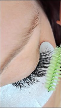 Close up of female eye with eyelash extensions ,eyelash extension procedure.2d volume, 3d volume, classical lashes,Russian volume,mega volume, new set.
