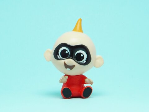 Indonesia - November 3, 2025 : Mini toy of action figure on hand at outdoor with blur background. Miniature photography concept design. Minifigure of Jack-Jack Parr character from The Incredible film.