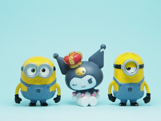 Fototapeta premium Indonesia - November 3, 2025 : Mini toy of action figure at outdoor with blurred background. Miniature photography concept design. Minions character from Despicable Me Cartoon film and Kuromi Sanrio.