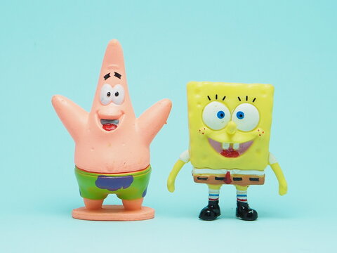 Indonesia - November 3, 2025 : Mini toy of action figure at outdoor with blurred background. Miniature photography concept design. Minifigure of Spongebob Squarepants character from cartoon film.