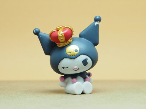 Indonesia - November 3, 2025 : Mini toy of action figure at outdoor with blurred background. Miniature photography concept design. Minifigure of Kuromi character from Sanrio Puroland. Art object.