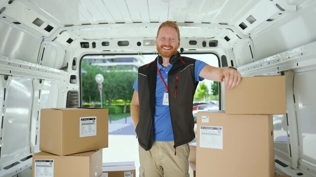 Courier leaning on a box inside a delivery van