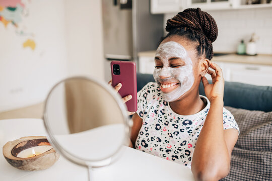 Closeup portrait of a happy african american woman doing skincare