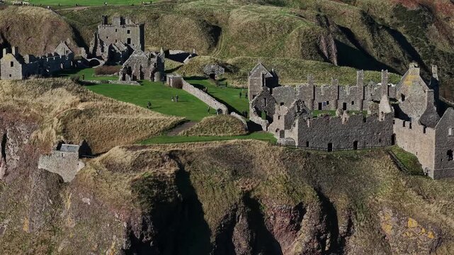 Beautiful cinematic Aerial footage of Dunnottar Castle and Dramatic Cliffs, Stonehaven Scotland &ndash; Historic Medieval Fortress on the North Sea	