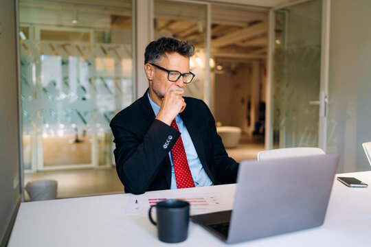 A man using a laptop in the office