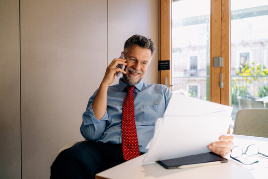 A man talking on a mobile phone in the office