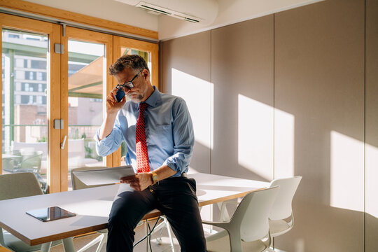 A man talking on a mobile phone in the office