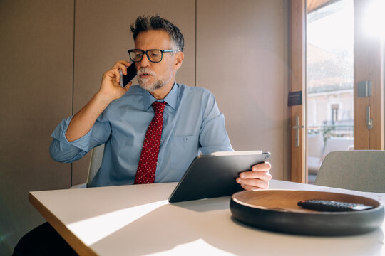 A man talking on a mobile phone in the office
