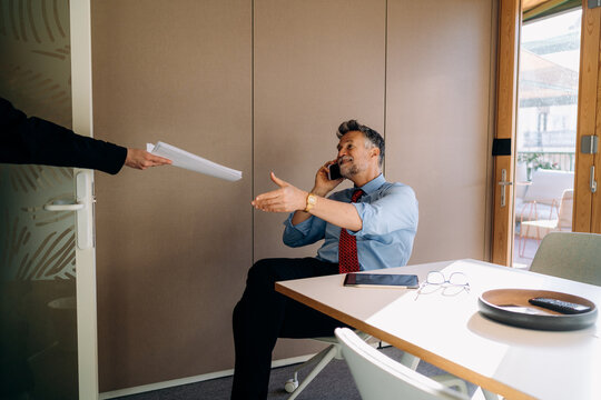 A man talking on a mobile phone in the office