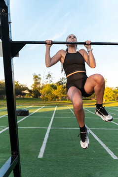 Urban athlte performing pull ups during calisthenics