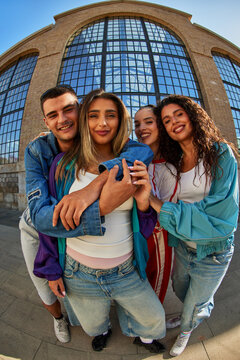Friends gather and pose for a picture in a city setting